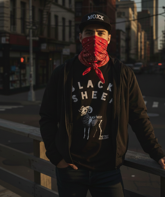 Person wearing a red bandana and black shirt with 'Black Sheep' graphic in an urban setting