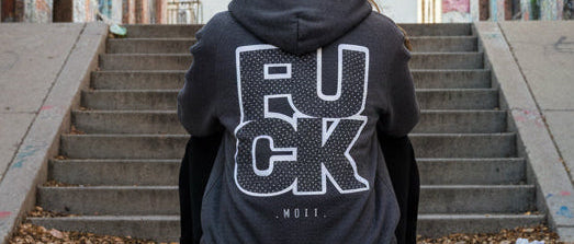 Dark gray hoodie with white text on the back against a white background