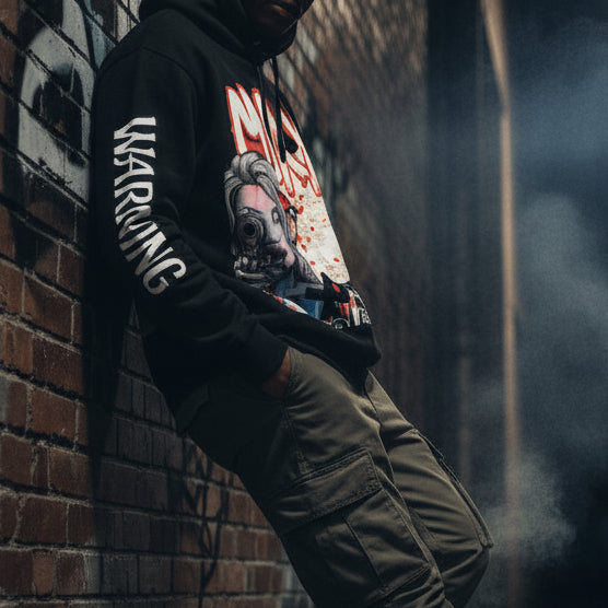 Black hoodie with graphic design on the back featuring a woman holding a gun and the word 'MOXX'.